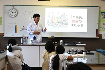 当社の開発メンバーから説明を受ける子ども達の写真